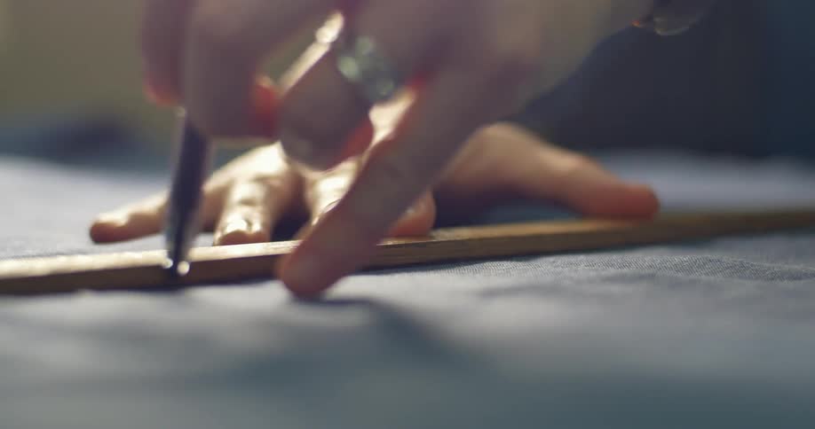 A ruler is used to trace a line