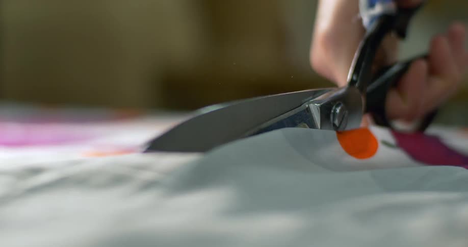 Scissors are used to cut some cloth