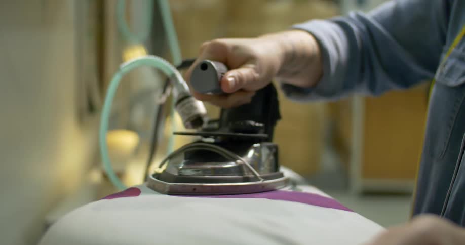 A woman ironing fabric