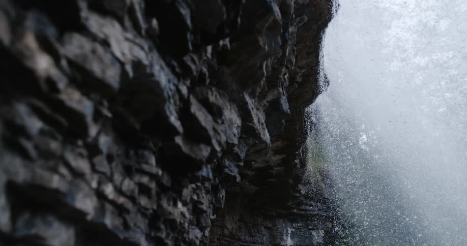 River water flowing over the rock edge and down the cliff in a waterfall