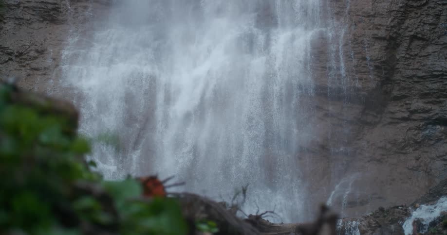 Slow motion footage of a waterfall is displayed
