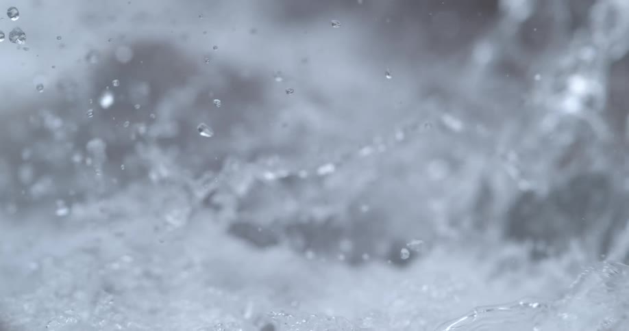 Turbulent water on the surface of a river rapids splashing at daytime