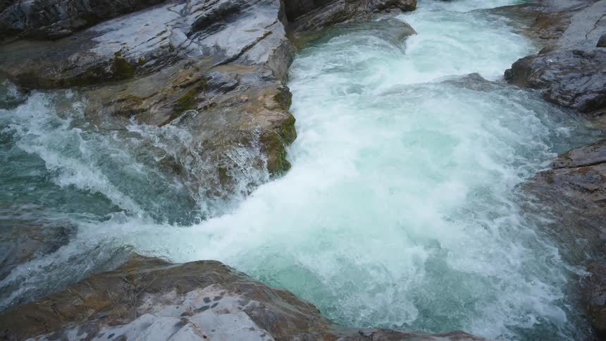 The view is of a water stream that is surrounded by a cliff