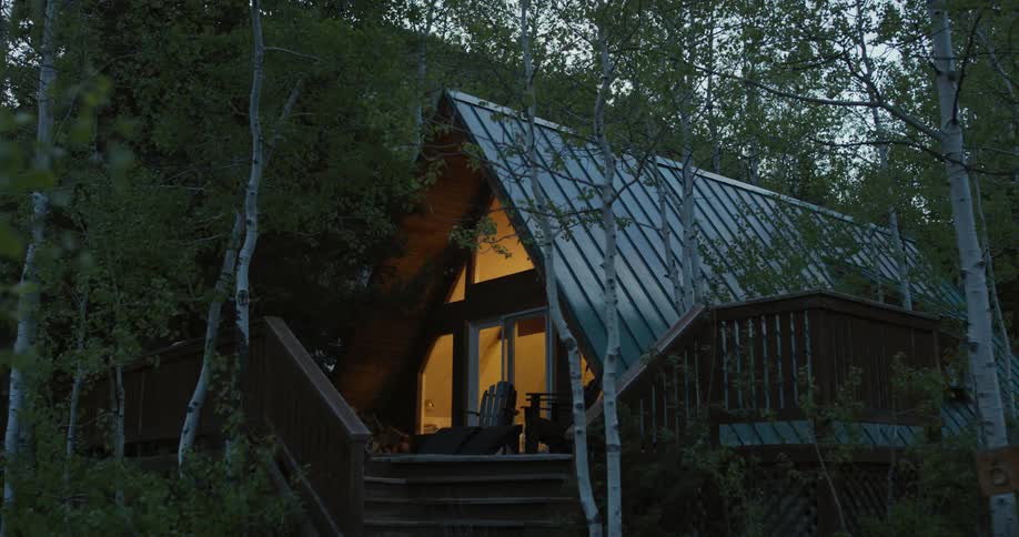 The view is of a cabin that is located in the forest area