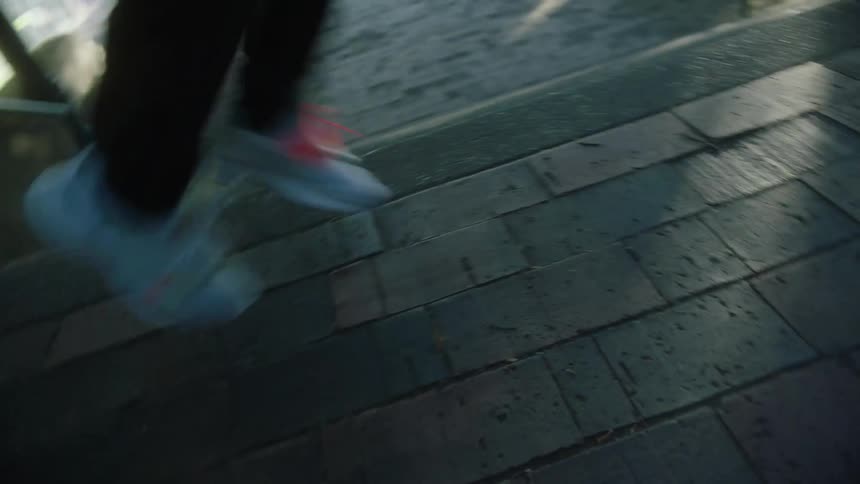A person is walking up a set of stairs in a city