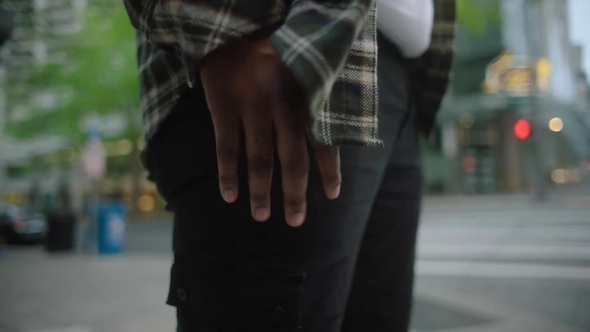 A man is standing on the street corner