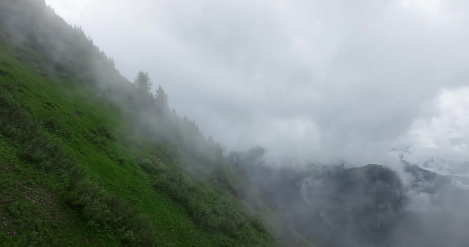 An aerial view of mountains with clouds