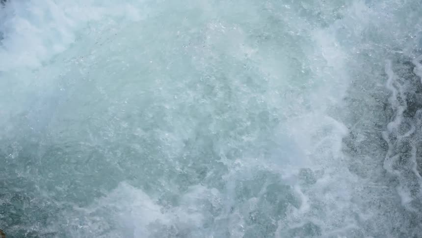 Water sparkles and splashes as it flows down the rapids