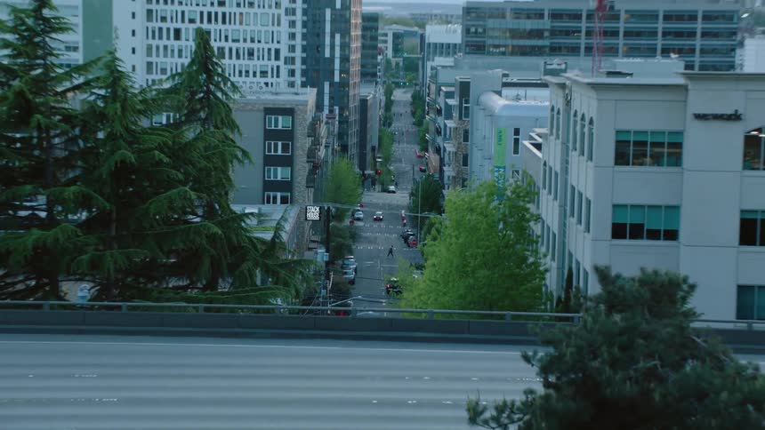 Aerial view of a man dancing in a city is displayed