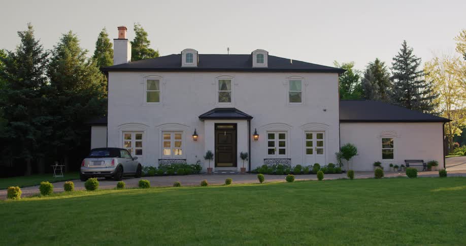 The view is of a big house located in the countryside