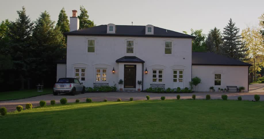 Exterior view of villa and car next to lawn