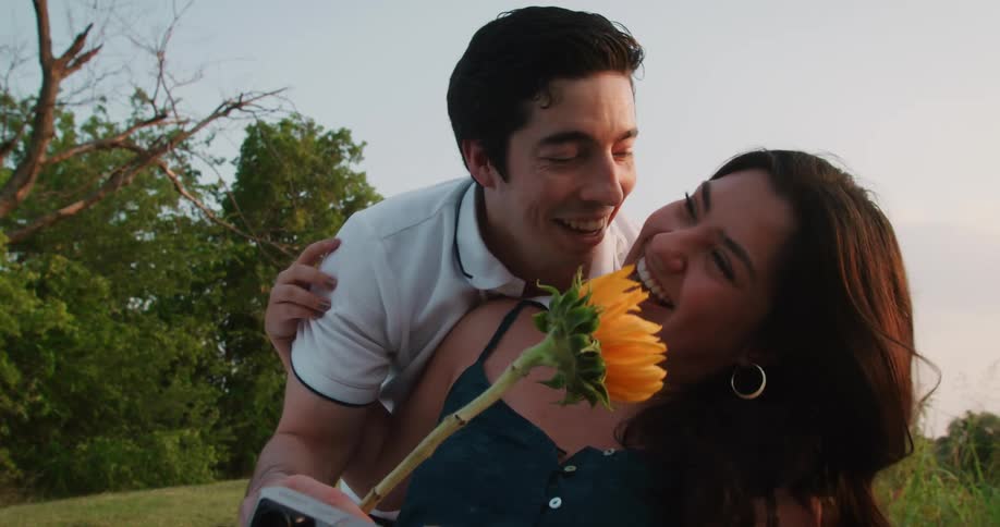 Man and woman are showing affection outdoors at dusk