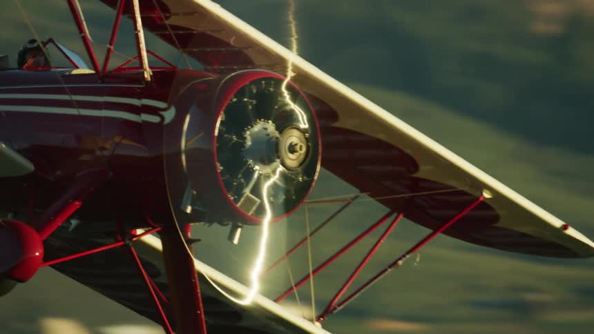 Aerial high energy shot of a person flying an airplane is shown