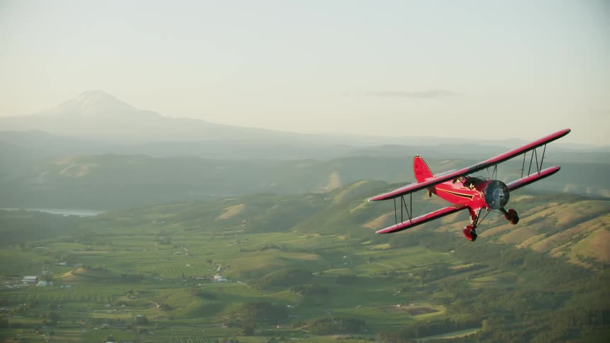 A view of a biplane flying outdoors