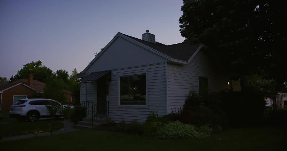 The view is of a house that is in the countryside at night time