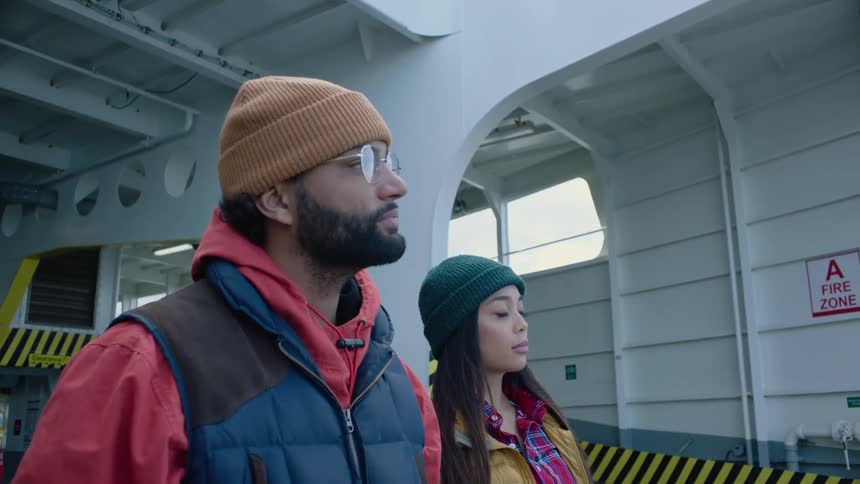Man and woman stand on ferry waiting