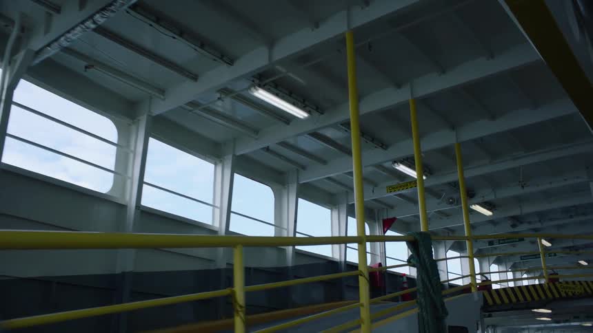 Yellow railings on a ramp going to the second floor of a parking garage