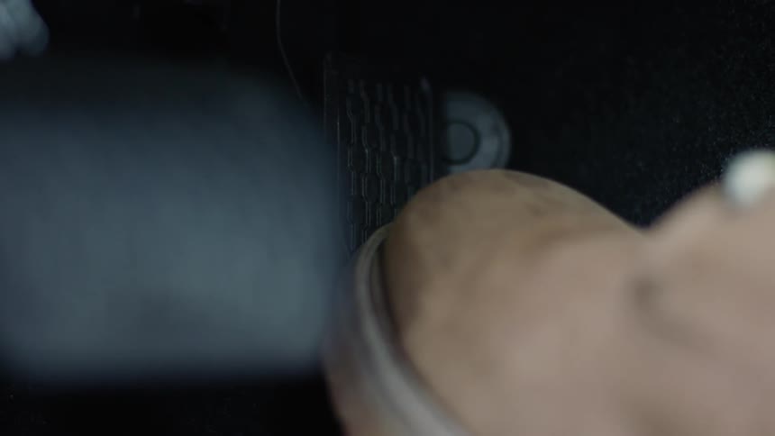 Someones boot is stepping on the pedal inside of there car