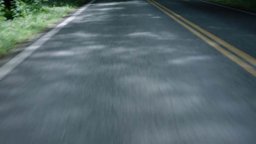 The road passes by on a sunny day