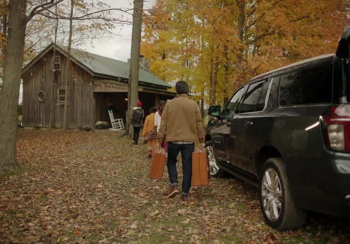 A family that is grabbing there luggage and walking into there cabin