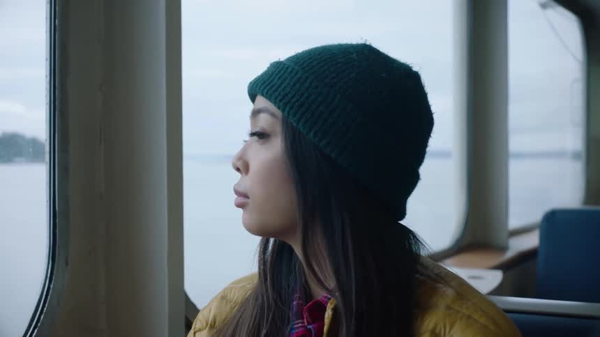 A woman is riding on the ferry