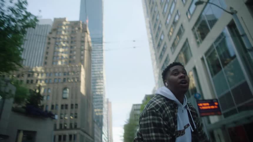 Young man energetically dancing on the empty city streets at morning