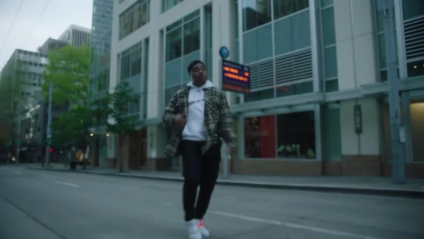 A man dancing outdoors in a street