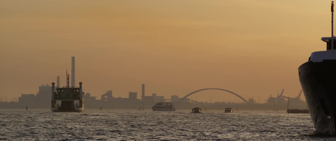 The view is of the lake with boats on it as you can see buildings from the distance