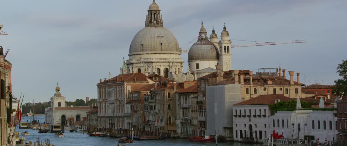 The view is of boats in the water and building around it