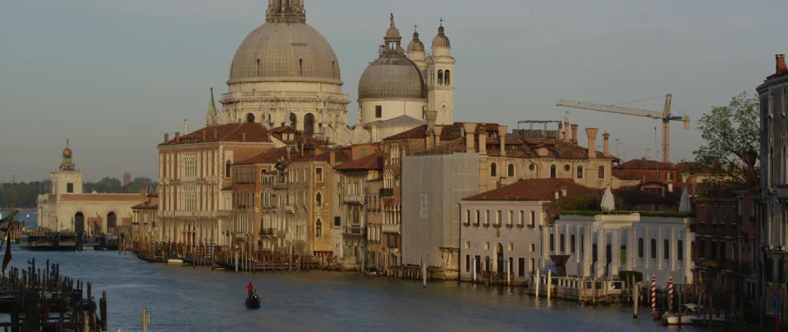 A gondola in the grand canal in venice approaching the basilica di santa maria della salute