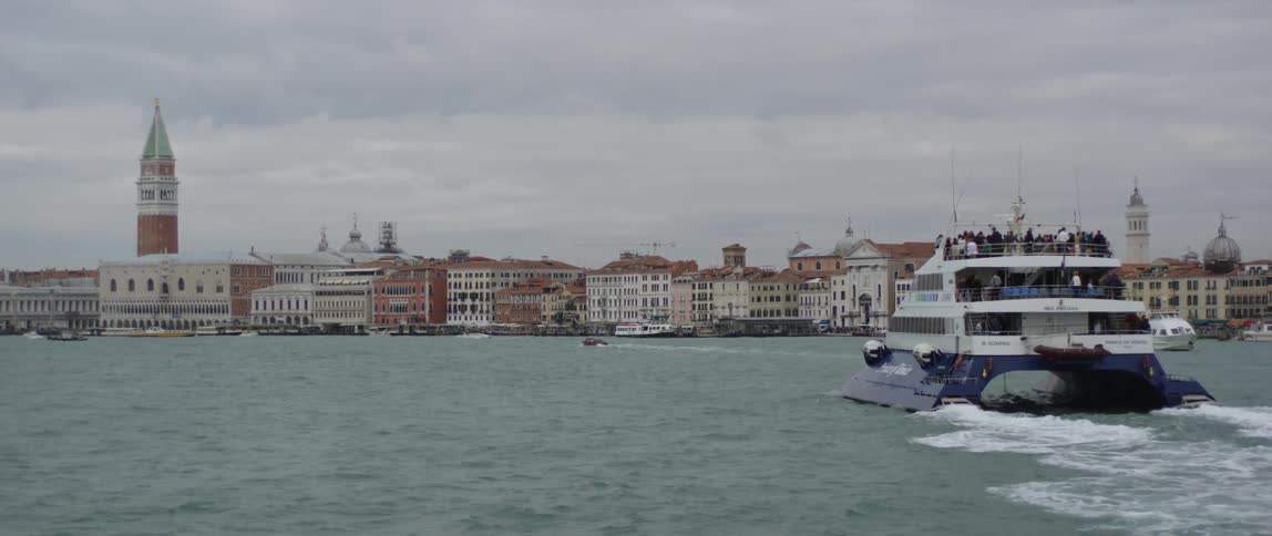 People are riding on a large boat over the ocean water
