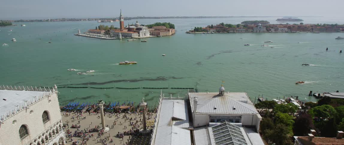 Aerial view of boats making way on the bay in front of the island of san giorgio maggiore on the coast of venice