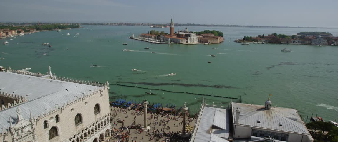 A view of the water and buildings are surrounding it