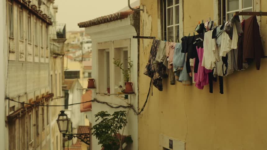Clothes drying outside a window on the side of a building in a town