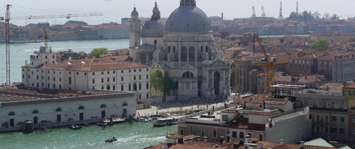 The view is of the city downtown area and boats in the river