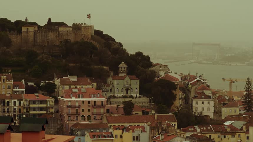 Aerial view of houses in a city during dusk is displayed