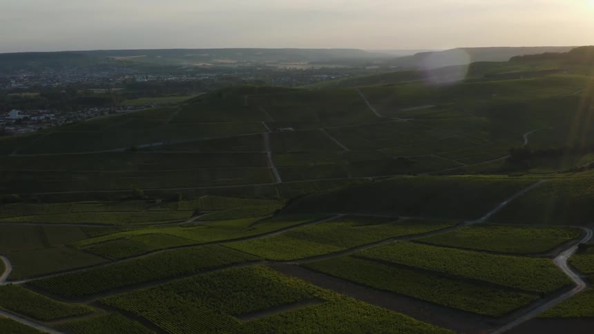 Rolling hills of farmland lead to a sprawling city
