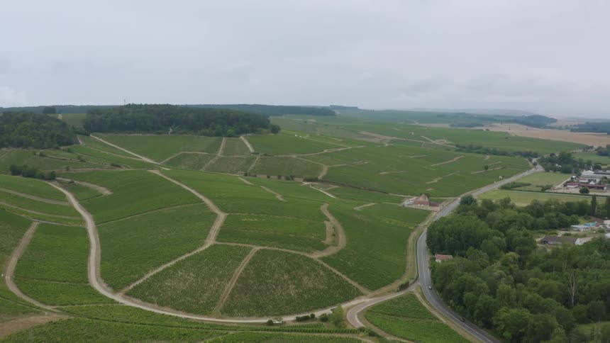 Road moves along highway passing homes and hills