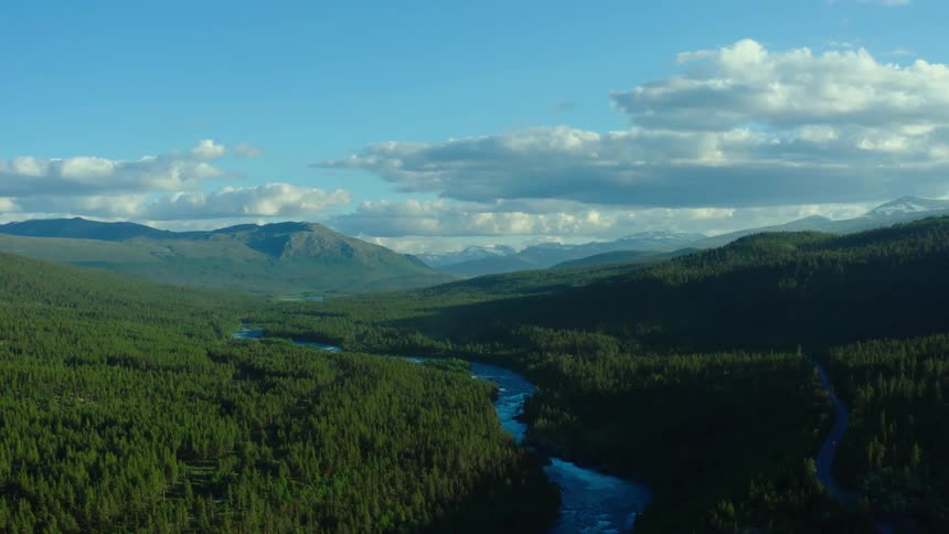 Aerial view of a creek in a grassland area is displayed