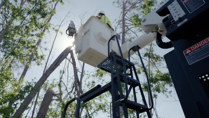 A person is being lifted up by a construction crane