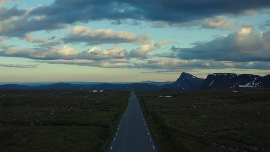 The sun is setting in the horizon of a rural area