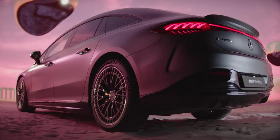 Sedan stands parked on sandunder a red tinted sky as two floating globs shade shape