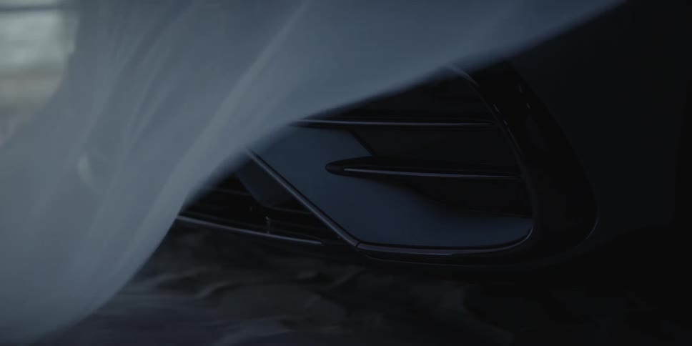 Thin fabric falls to briefly veil front of parked vehicle