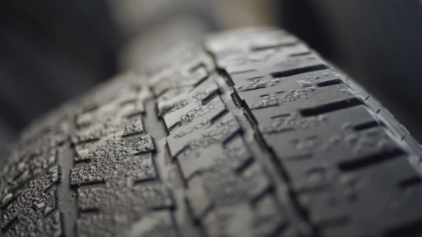 Extreme close up of the surface of a damaged car tire on dumpster at daytime