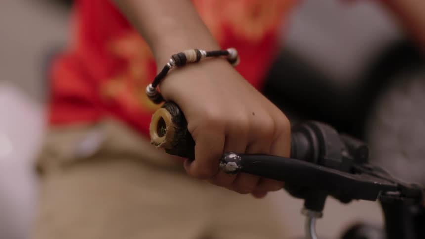 Close up of the hand of a young person throttling up a motorcycle