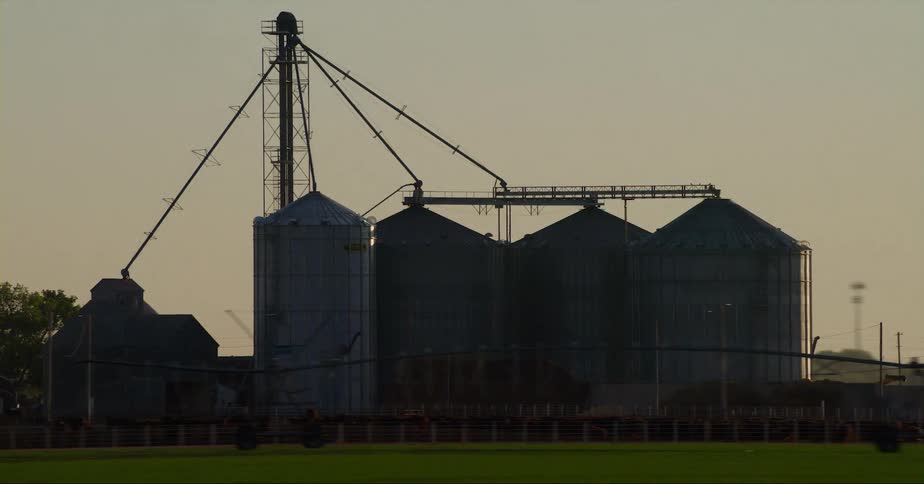 Equipment is displayed on a farm during dusk