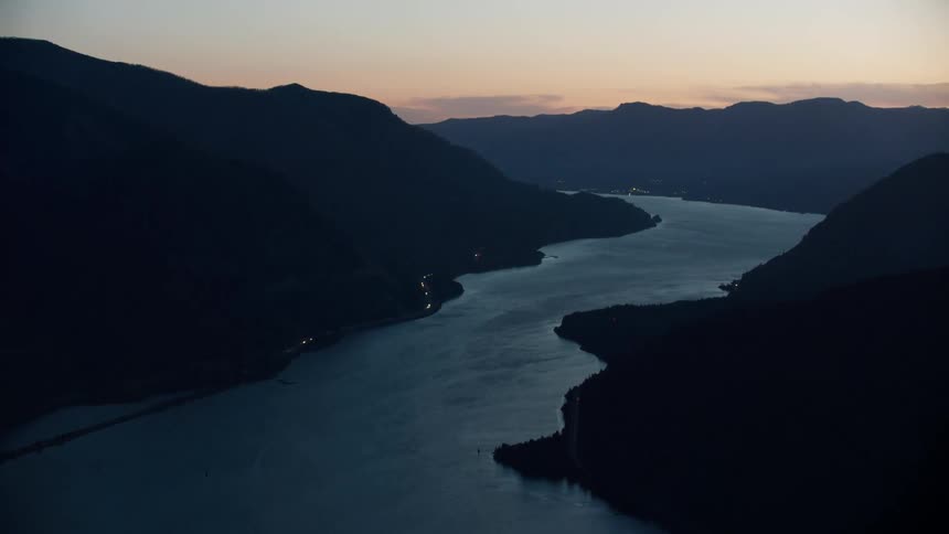 Blue hour time lapse flying straight down the Columbia River in gorgeous blue hour light after the sun has gone down in this aerial shot