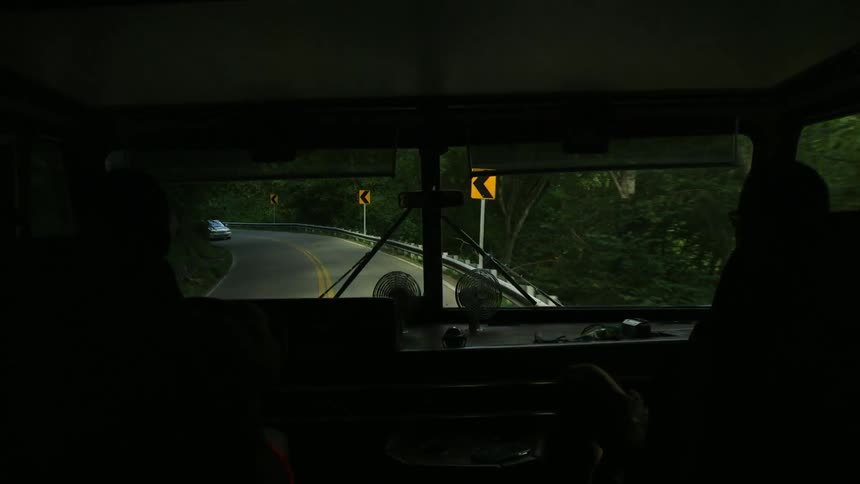 Inside an rv a car passes on a winding road