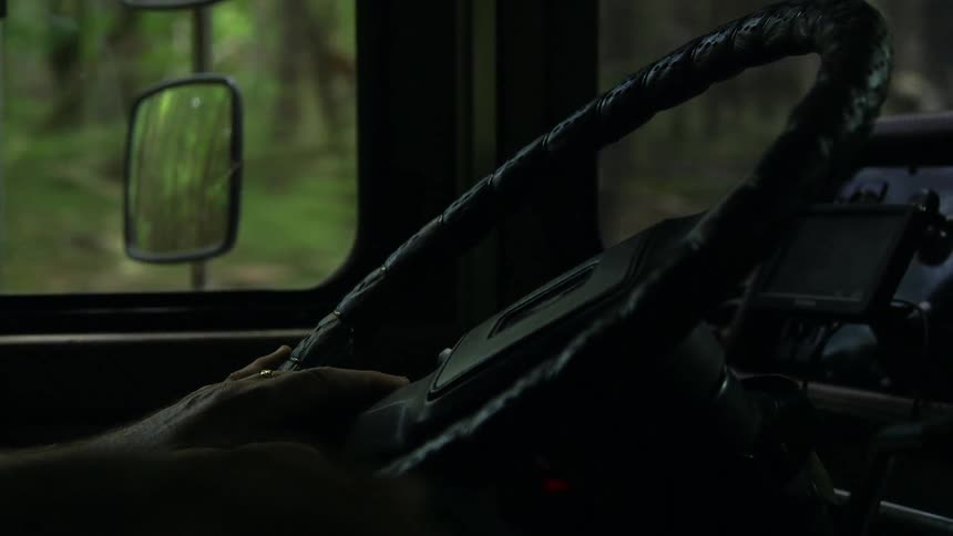 Close up of a hand on a steering wheel