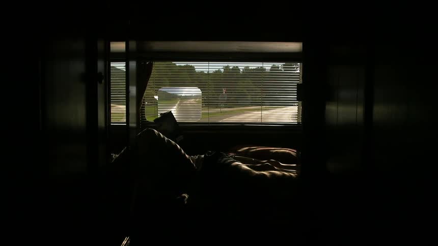 A person is reading in an rv bed